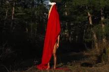 photo of a person in the nature, covered with red fabric